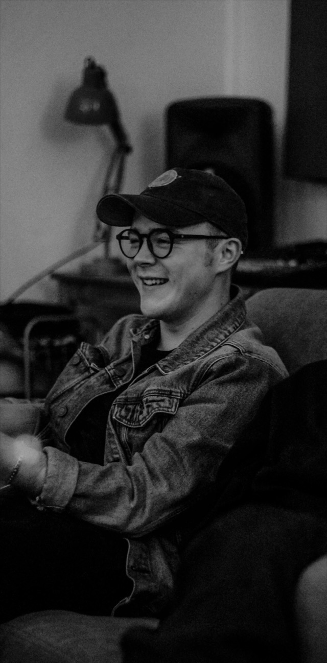 Louie laughing in the studio — black and white portrait