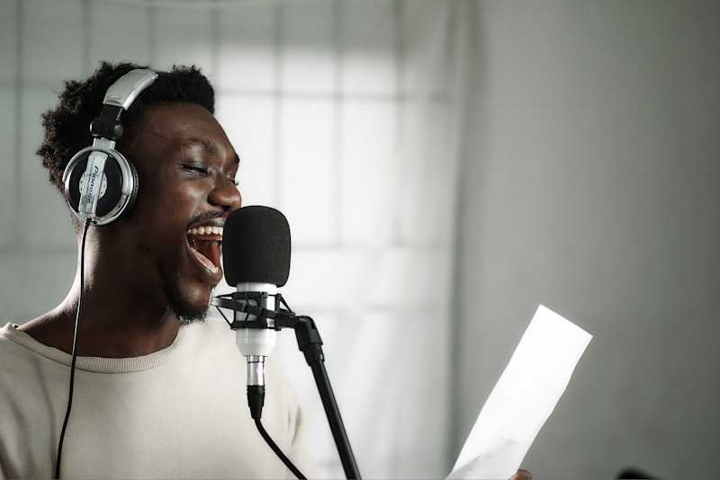 Man singing into a microphone with headphones