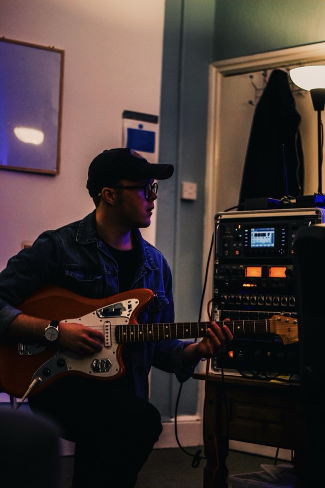 Louie in his East Lothian studio with his guitar and recording gear
